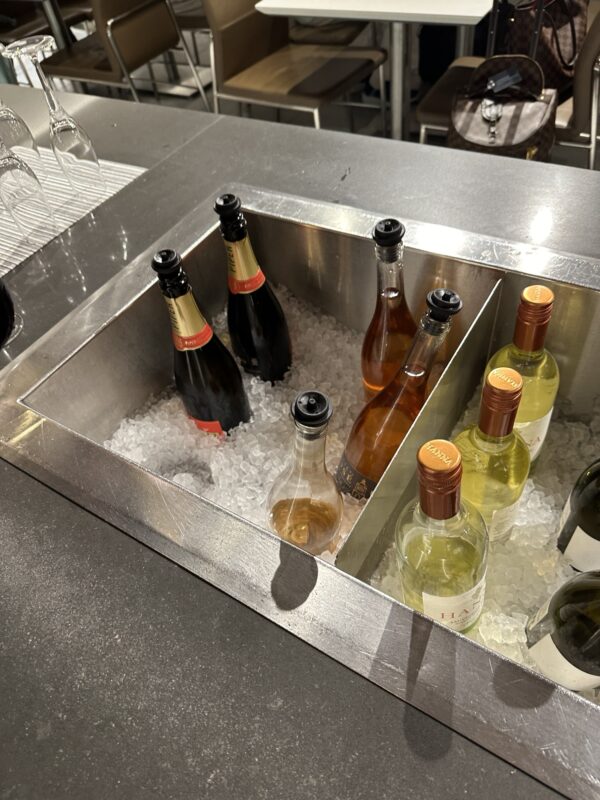 a group of bottles in a metal sink