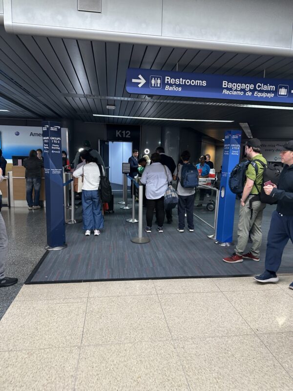 a group of people standing in a line in a building