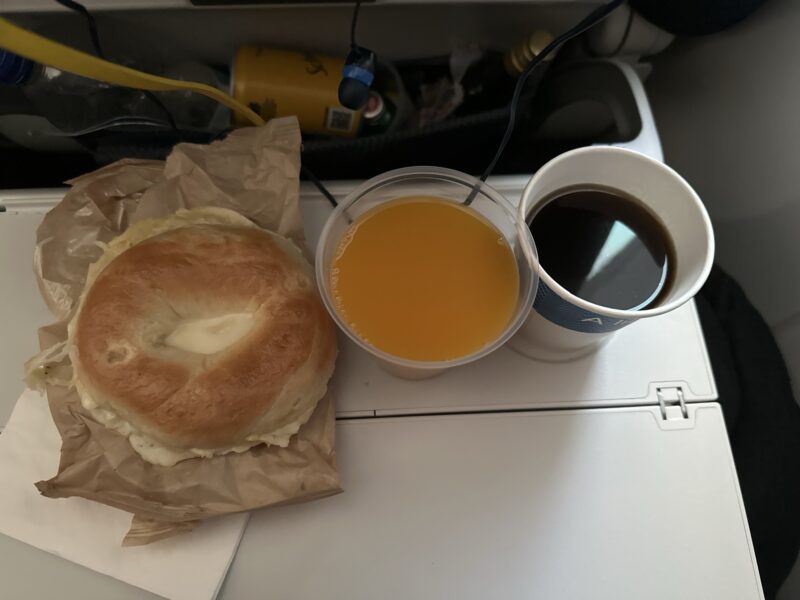 a bagel and a cup of coffee on a table