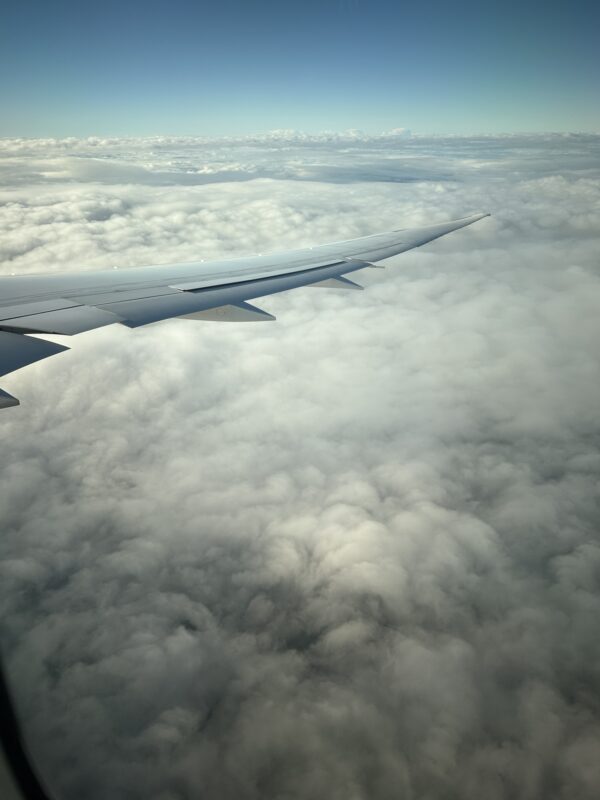 an airplane wing above the clouds