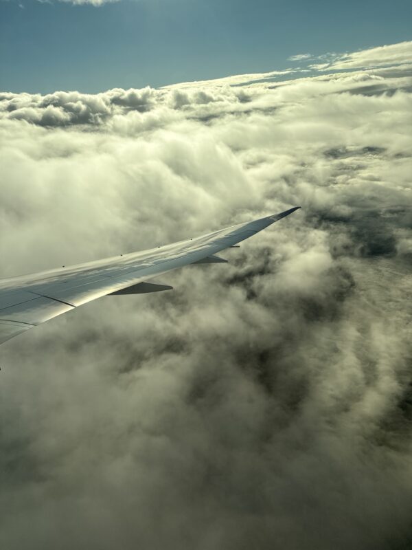 an airplane wing above clouds