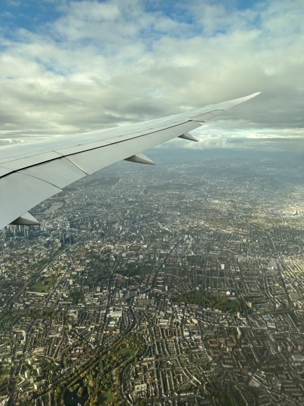 an airplane wing and city below