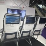 a group of seats with screens on the back