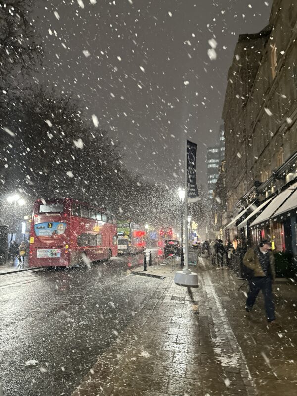 a snow falling on a city street