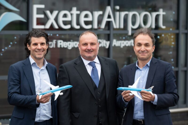 a group of men holding toy airplanes