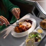 a person eating food on a tray