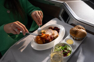 a person eating food on a tray