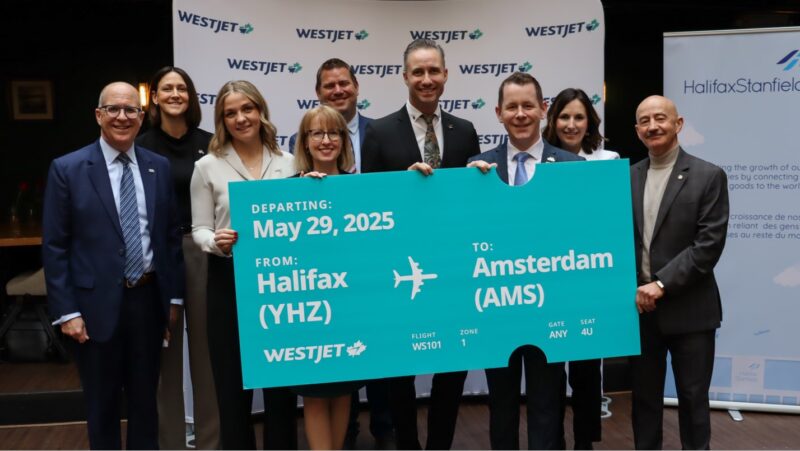 a group of people holding a large piece of paper