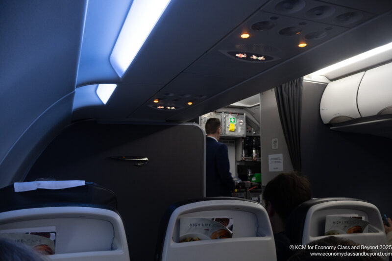 a person in a suit standing in an airplane