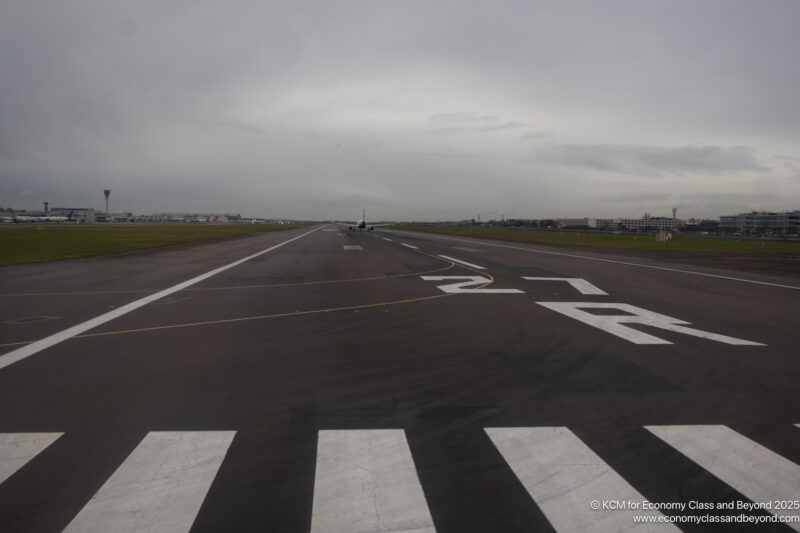 an airport runway with a plane on the runway