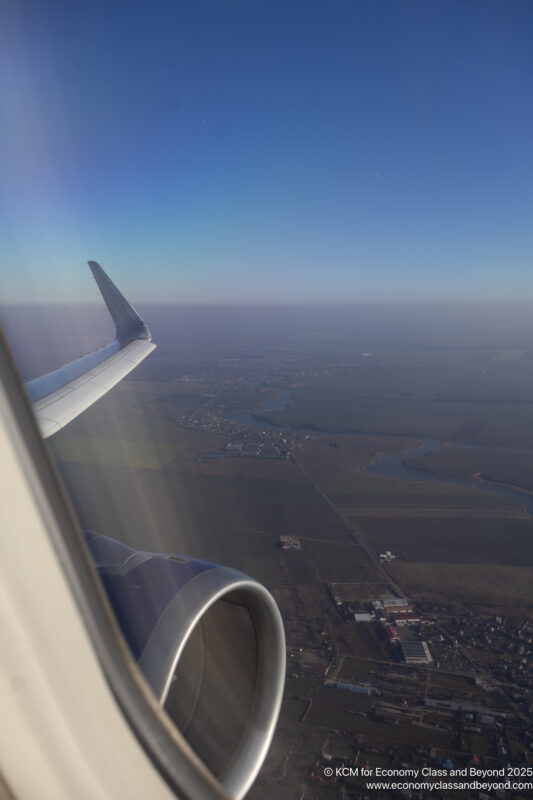 an airplane wing and a landscape