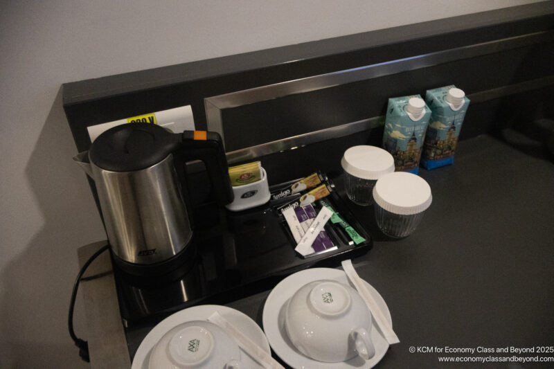 a coffee pot and cups on a counter