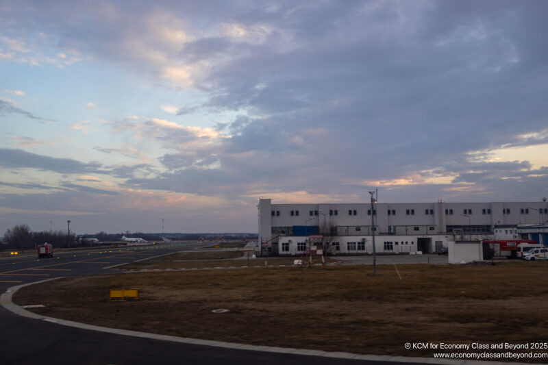 a building with a runway and a parking lot