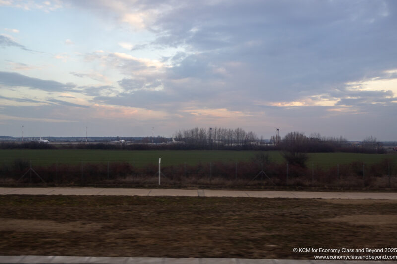 a field with grass and trees in the distance