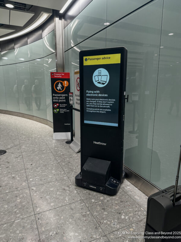 a black electronic sign next to a glass wall