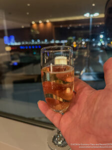 a hand holding a glass of liquid