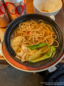 a bowl of soup with noodles and vegetables