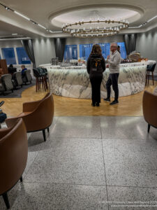 a man and woman standing in a room with a marble counter