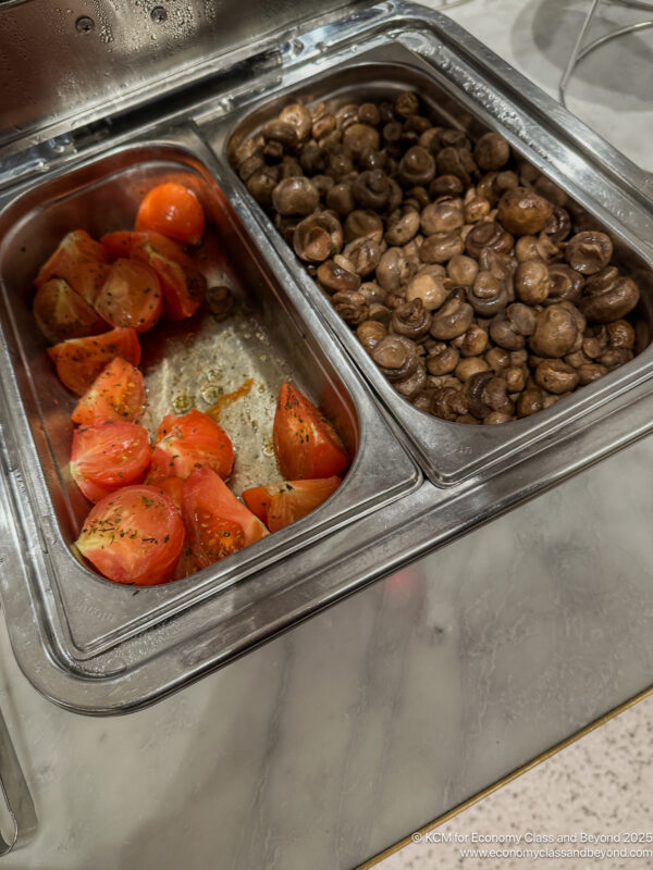 a tray of food with tomatoes and mushrooms