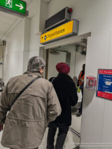 a man and woman standing in front of a door