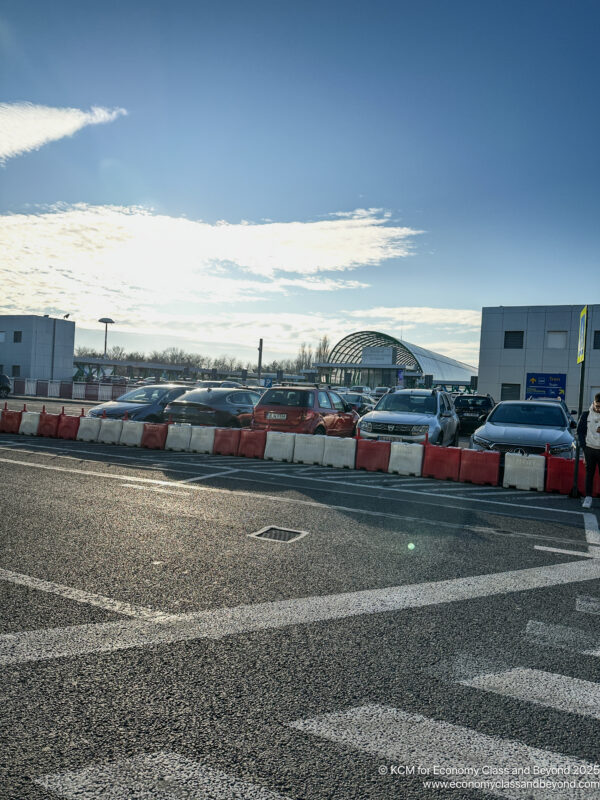 a parking lot with cars parked in front of a building