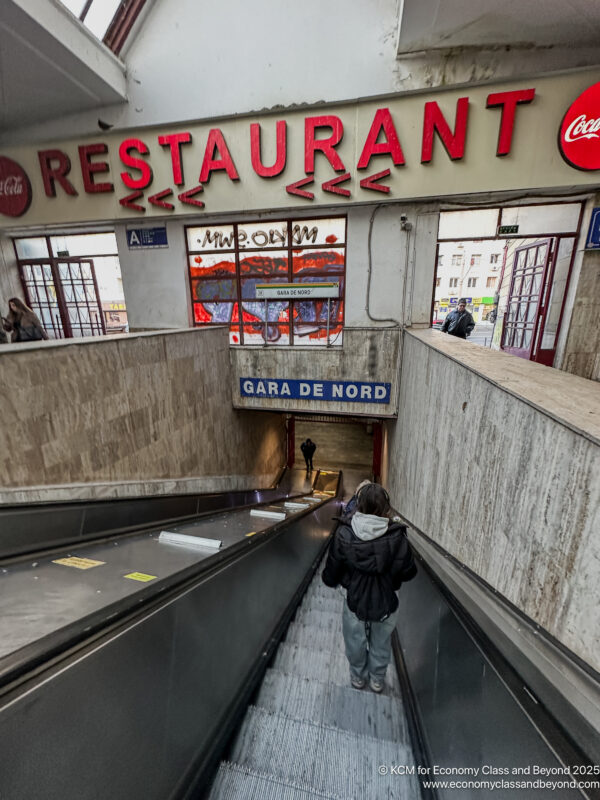 a person walking down an escalator