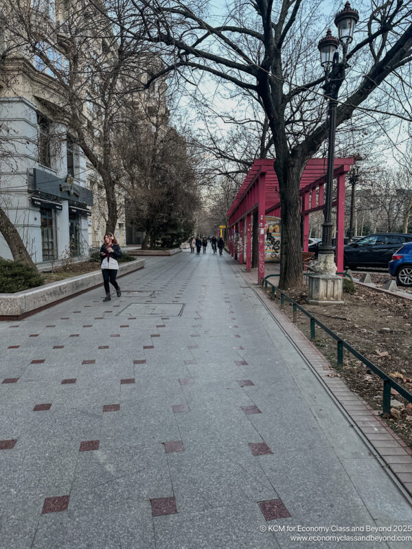 a woman walking on a sidewalk