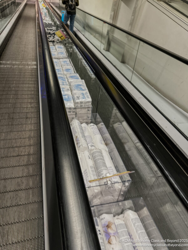 a conveyor belt with packages of toilet paper