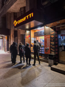 a group of people standing outside a store