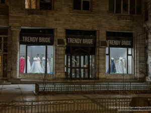 a building with a storefront with a few dresses in it