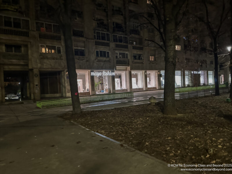 a building with storefronts at night