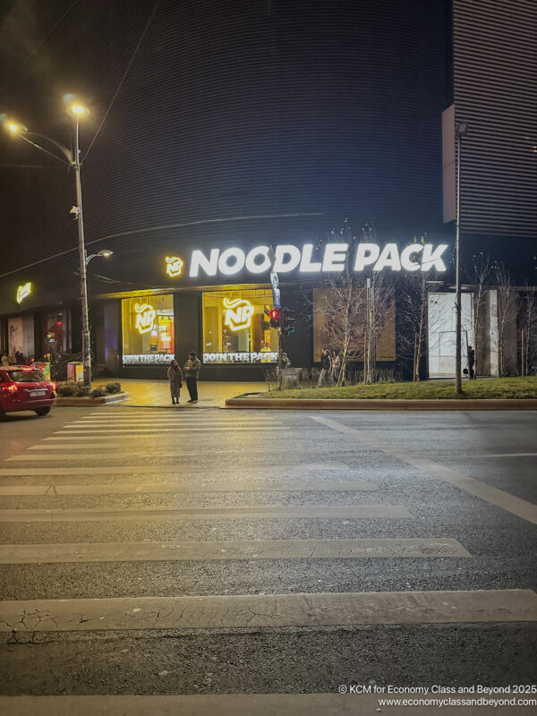 a street with a building and a sign