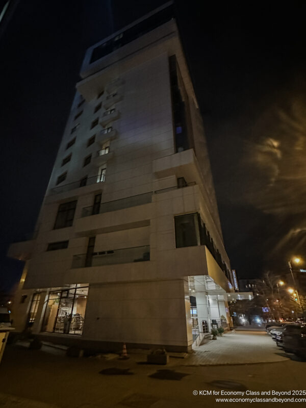 a building with a parking lot and a parking lot at night