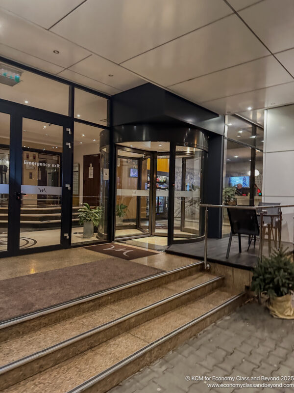 a building with glass doors and stairs