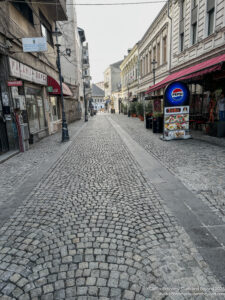 a stone street with buildings and shops