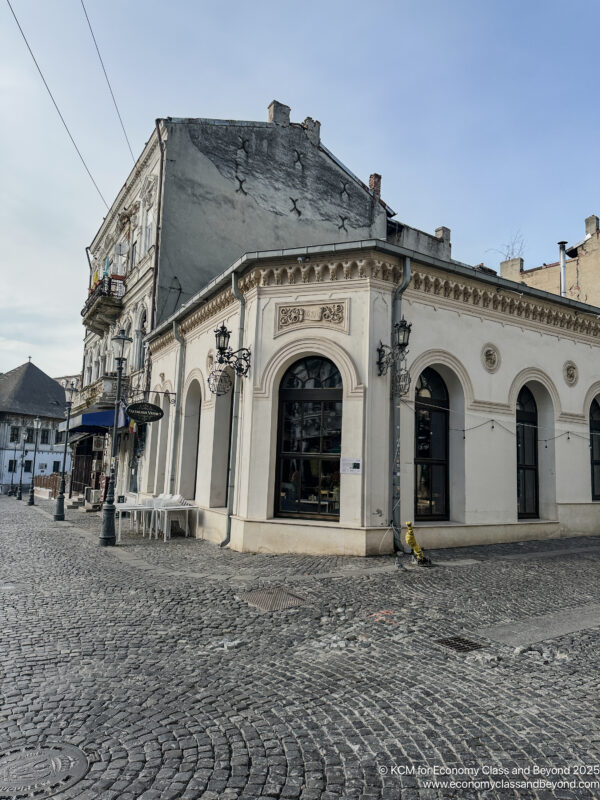 a building with a stone wall and a stone road