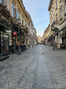 a street with buildings and shops on either side