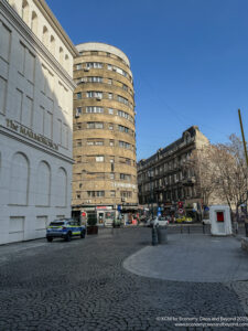 a street with a circular building and police car