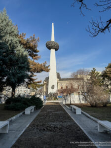 a white tower with a circular object in the middle