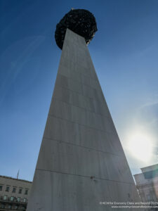 a tall tower with a round object on top