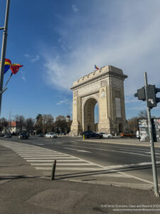 a large stone arch with flags on the side of it