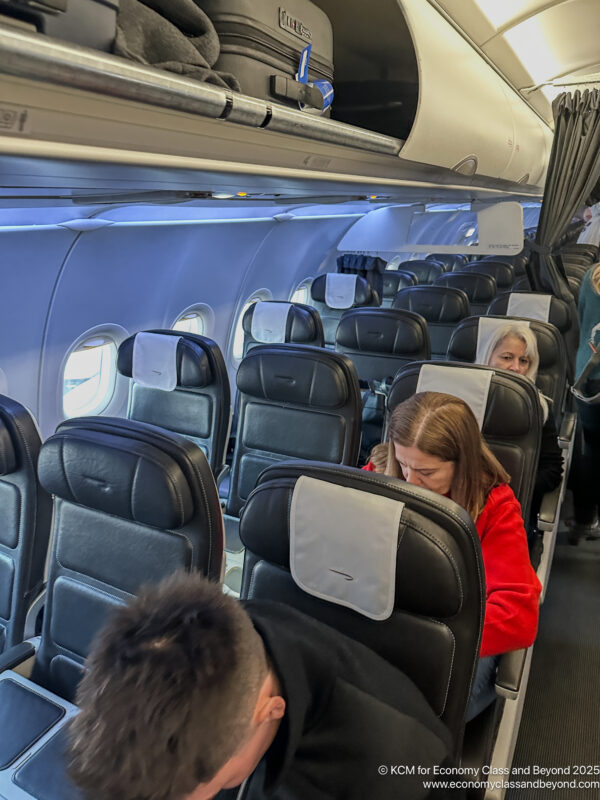 people sitting in chairs on an airplane