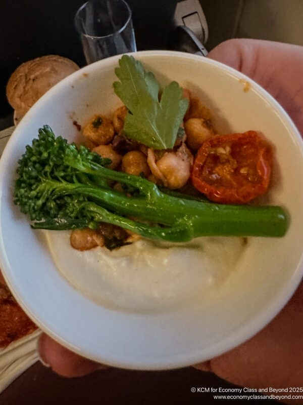 a bowl of food with broccoli and tomatoes