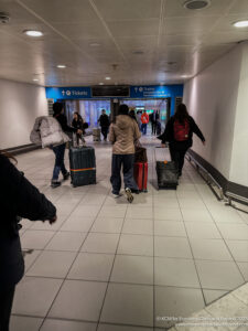 people walking through a building with luggage