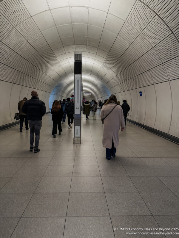 a group of people walking in a tunnel