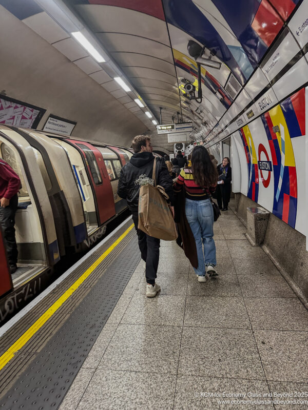 a group of people walking in a subway station