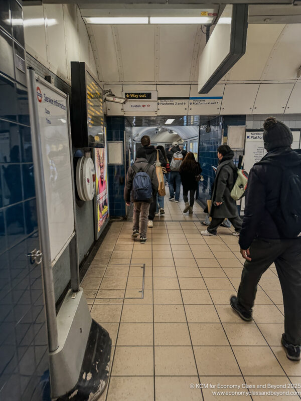 a group of people walking in a subway