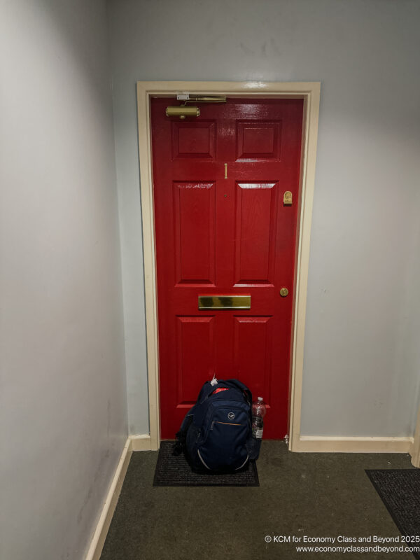 a red door with a backpack on it