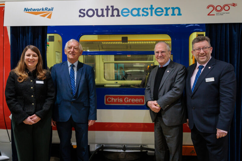 a group of people standing in front of a train