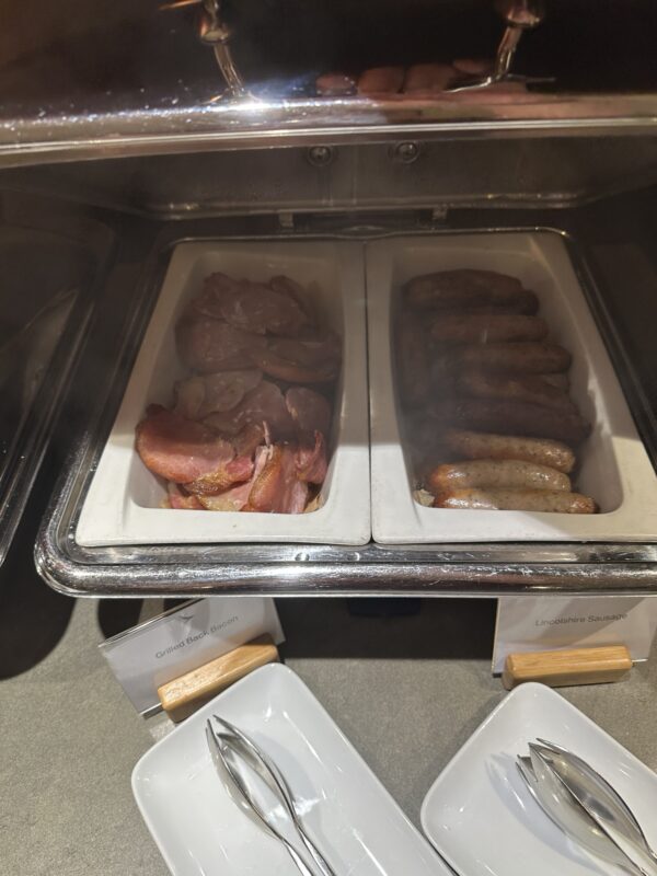 a trays of meat and sausages in a buffet